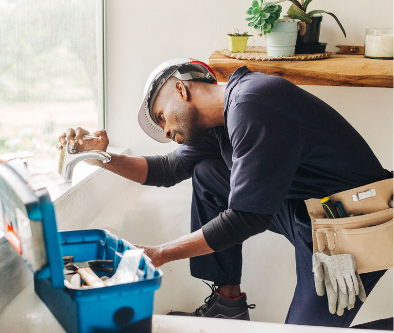 Technician working on plumbing fixture